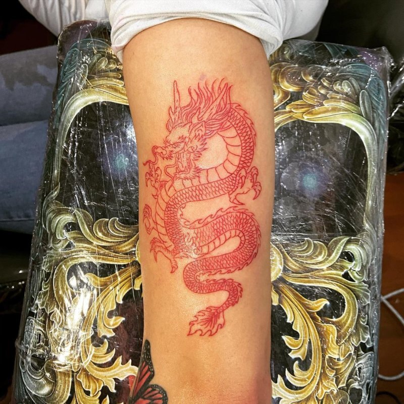 Red tattoo pigment being treated with a laser — illustration for an article on why red ink resists removal